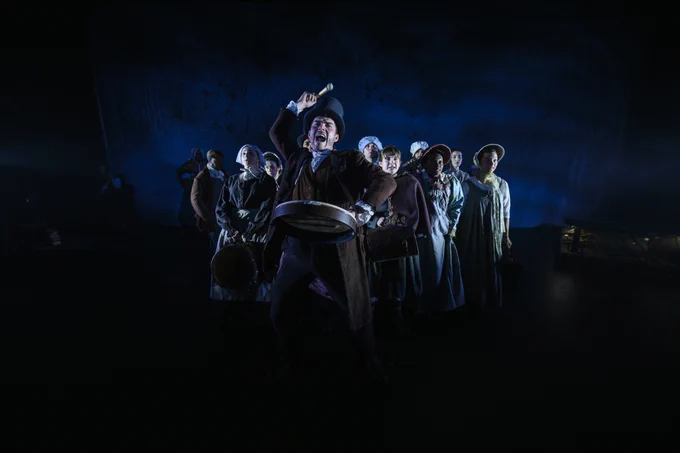 The cast of Jane Eyre posing against a dark backdrop.