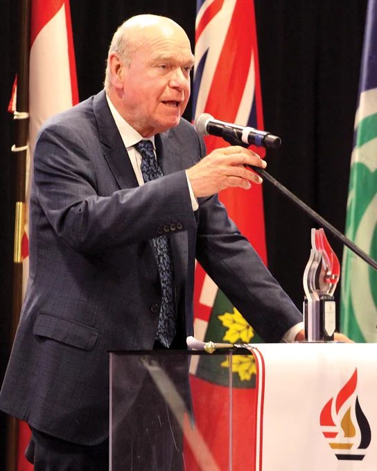 Dr. Mark Aubry gives a speech at the podium from his induction into the Ottawa Sports Hall of Fame