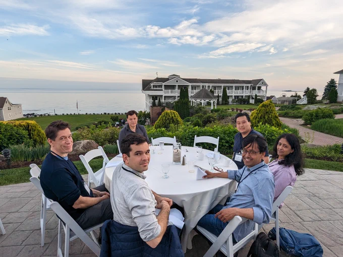 A group of neuroscientists seated around a dinner table