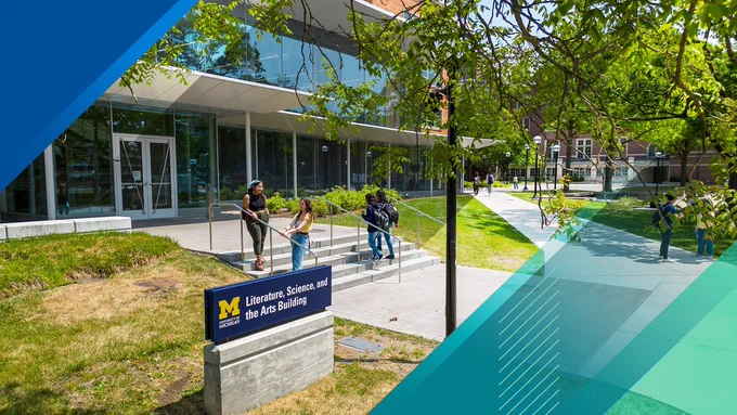 LSA building with four students standing in front.