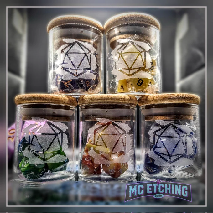 Five small jars filled with gaming dice and etched with a D20 design. 