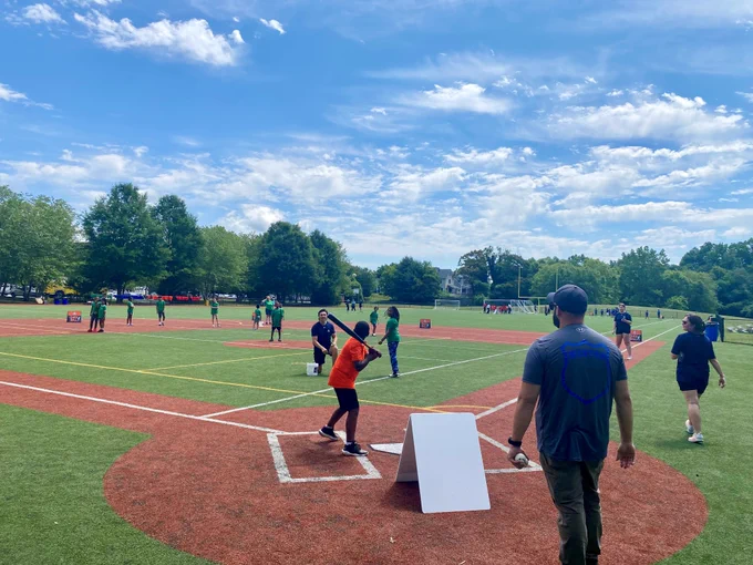 A group of youth ballplayers ready for the pitch to be hit.