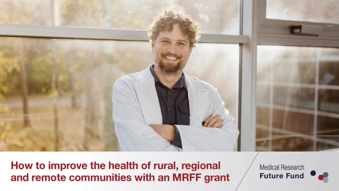 A photograph of a smiling man in a white laboratory coat with his arms folded, and his back to a window with the sun shining through. Below is a grey banner with red text that reads, “How to improve the health of rural, regional and remote communities with an MRFF grant” beside the logo of the Medical Research Future Fund.