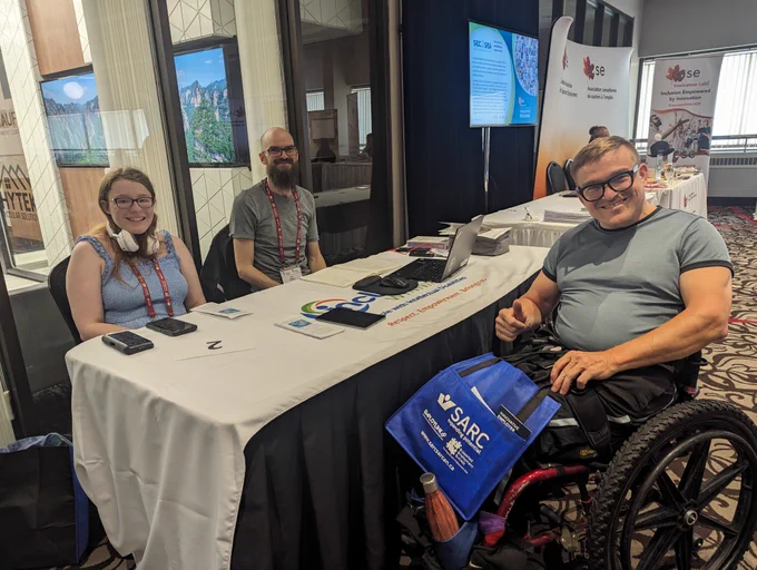 Exhibitors and guests at #29thCASEConference, Inclusion Winnipeg table.