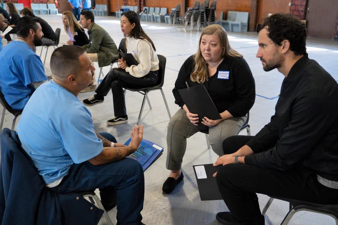 Defy Ventures volunteers coach incarcerated entrepreneurs-in-training at the California Rehabilitation Center in Norco. 