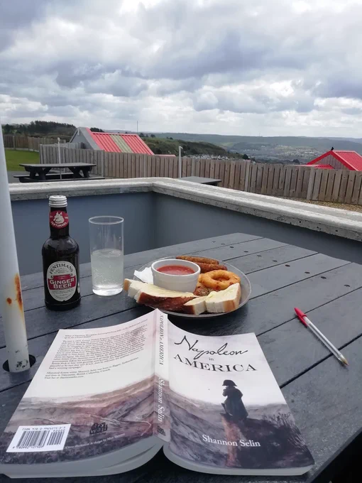 Showing the book Napoleon in America by Shannon Selin, open whilst eating breakfast at Constitution Hill, Abeystwyth