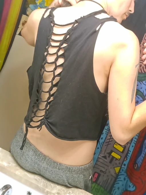 Dune's back in a cut croptop with loops running down the back, leaving plenty to see