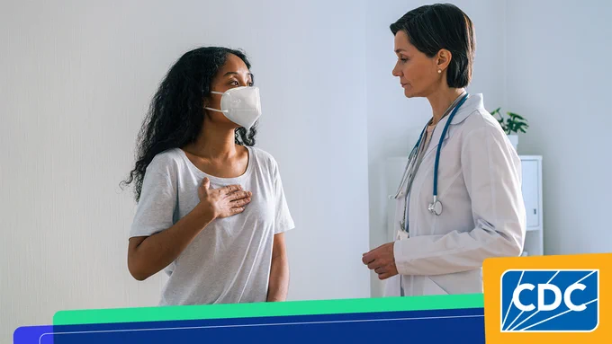 Masked woman speaking to a physician. CDC logo bottom right corner.