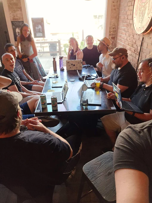buncha folks drinking at a bar and making many javascripts