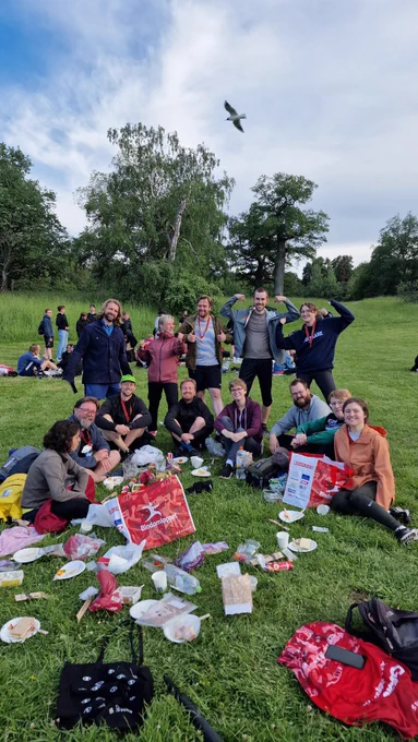 Team photo of the Johannesson Lab members after running the blodomloppet. Grocery bags and picnic things are in the midst.  