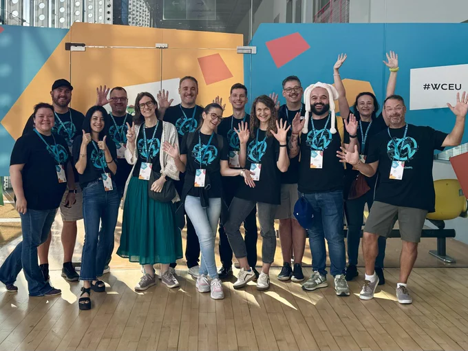 A team photo of the GoDaddy staff in branded shirts.