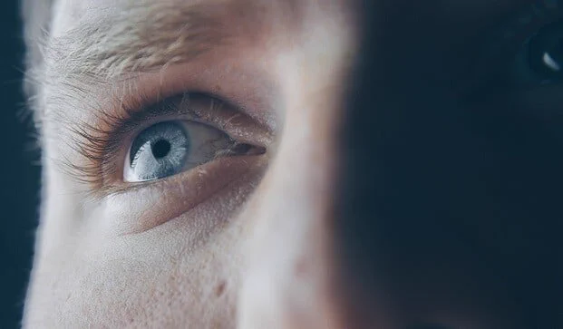 Close up image of a person's eye looking into the distance.
