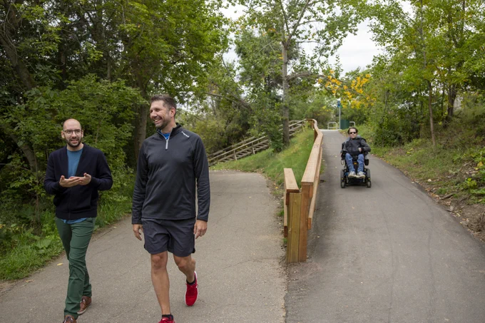 Three people using paved river valley multi-use trails