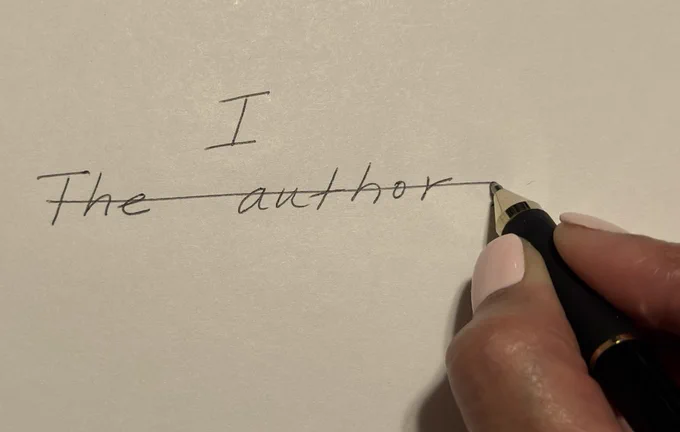 An hand using a pen to cross out the phrase, "The author." 