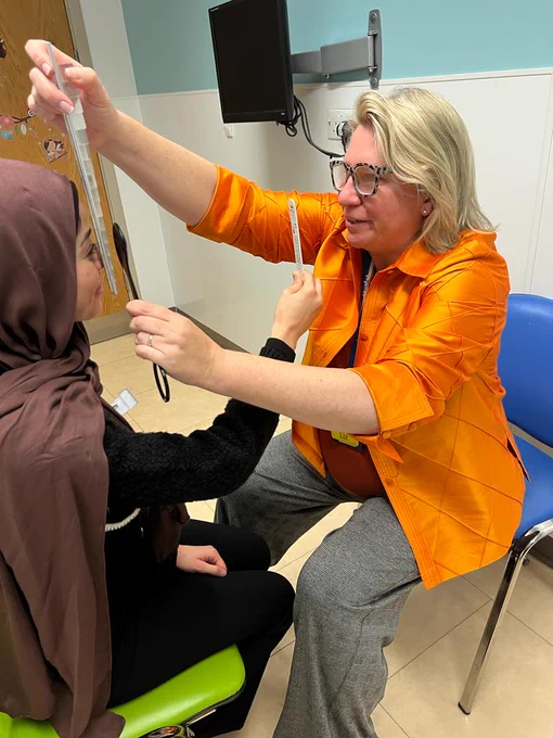 The Master Liz Shilling, Orthoptist at St Thomas' hospital, using a prism bar to test a patient's vision.