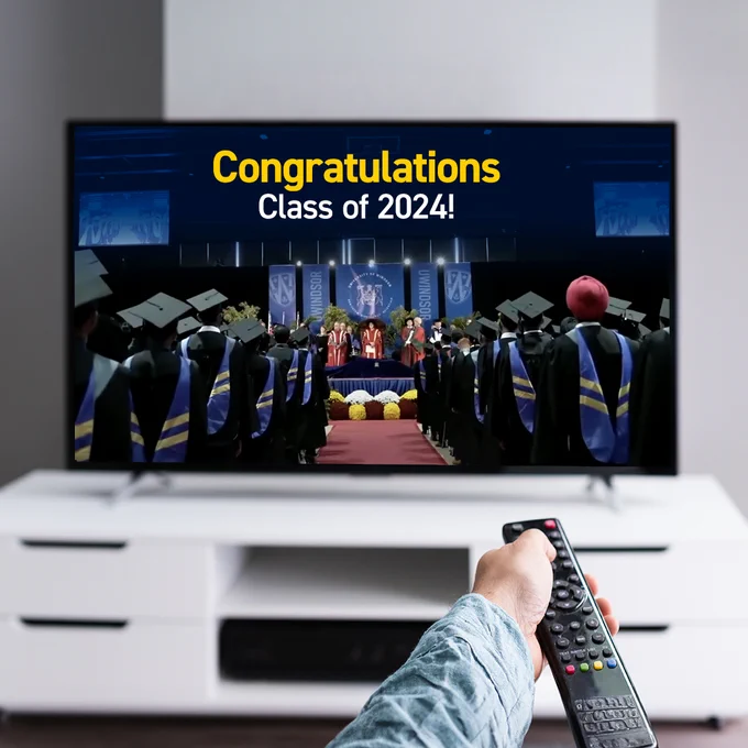 Person with remote and watching tv screen
