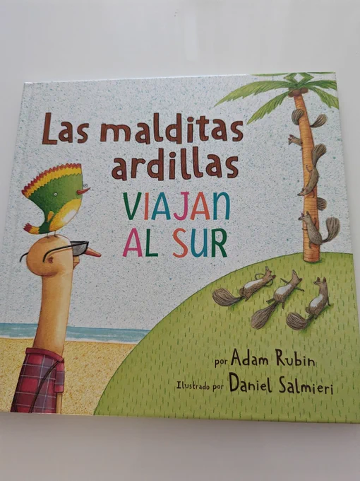 Foto de la cubierta de Las malditas ardillas viajan al sur. Se ve al viejo Florencio con un pájaro de colores en la cabeza, mirando a las ardillas, que están tiradas tomando el sol en una colina verde con vistas al mar (algunas están encaramadas a una palmera).
