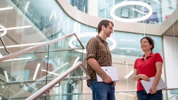Two colleagues talking in the Advanced Research Centre.