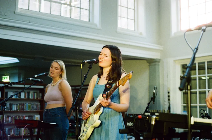 A photo of the band Marnie Glum playing a gig in York Explore Library.