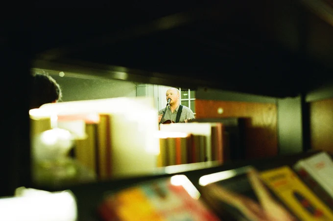 A photo of Rowan playing a gig in York Explore Library.