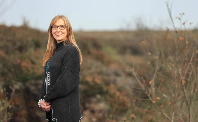 Woman smiling in autumnal setting