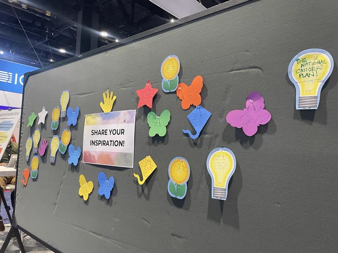 Bulletin board with colorful notes and text: Share your inspiration