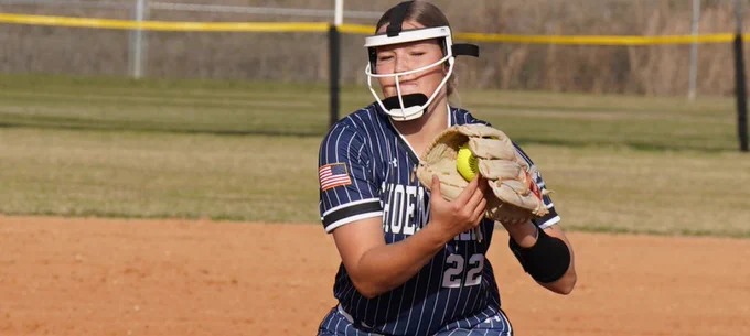 Softball player catches the ball