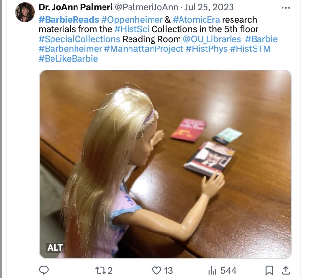Image of social media post showing nurse Barbie reading books about Oppenheimer and the Manhattan Project in a Reading Room.