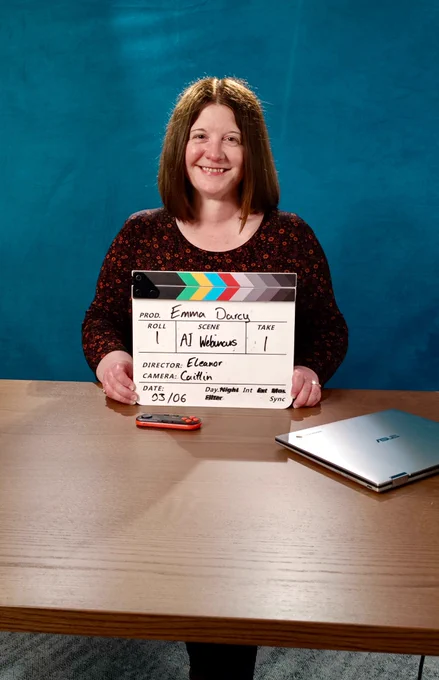 Emma Darcy holding a clapperboard in the National College Studios.
