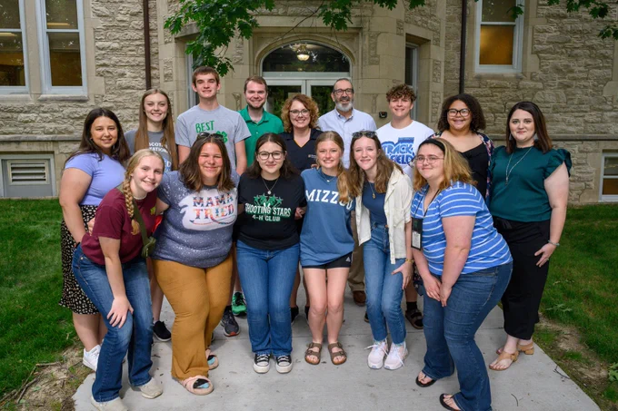 Vice Chancellor for Extension and Engagement, Chad Higgins, poses outside Whitten Hall with the State 4-H Council and staff. 
