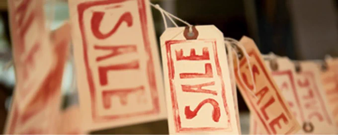 Tags with the the word SALE are hung from a string