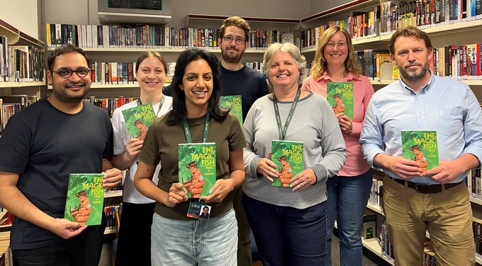 A group of teachers holding books.