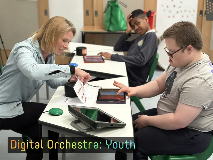 DMS Musician, Abi leads the group with two boys playing Figurenotes on Thumbjam on iPad.