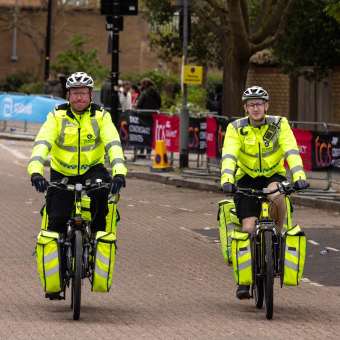 Two St John Ambulance Cycle Responders, on their bikes at the London Marathon
