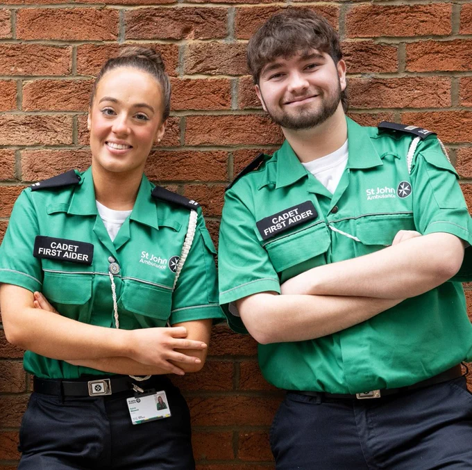 Two St John Cadets, standing together and smiling