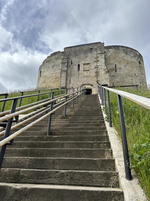 Looking up 50  stone steps to the stone tower at the top of it.