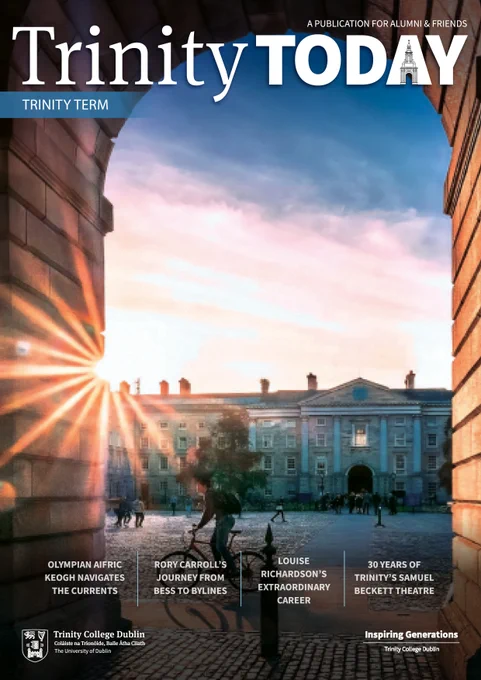 Campus image shot from under front arch with sun peaking through, man on cycling past the arch