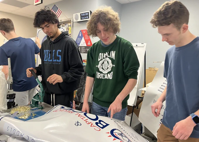 Students work on a sign