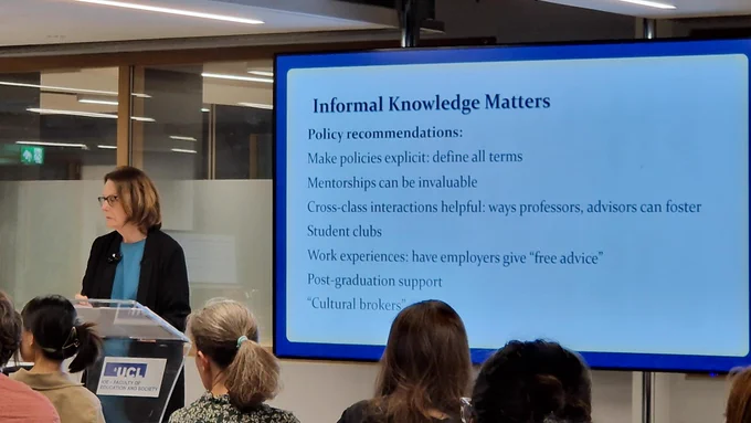 Annette in front of a slide on how informal knowledge matters.