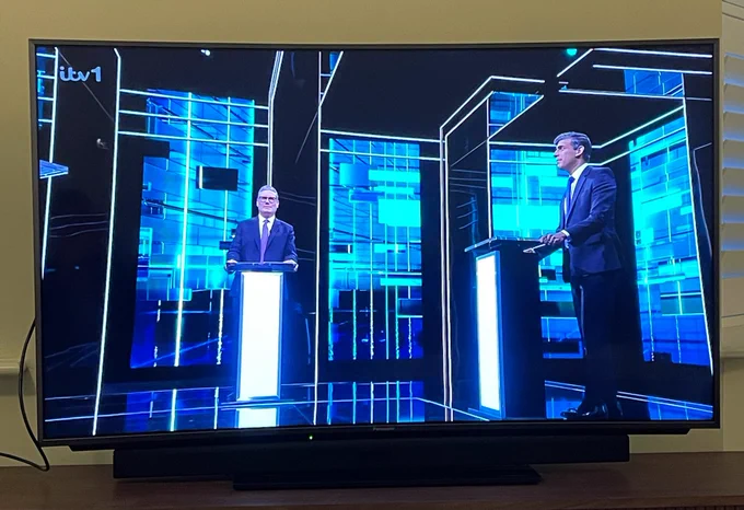Leadership debate on a neon futuristic backdrop on itv
