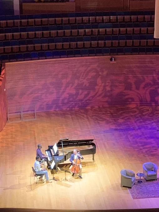 World-renowned musician Yo-Yo Ma performing on stage with two other male music.
