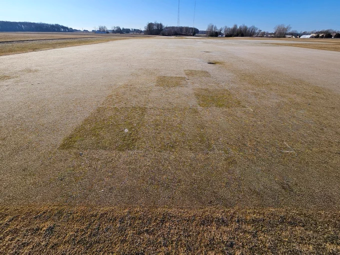 Turfgrass research area with individual plots showing varying levels of frost.