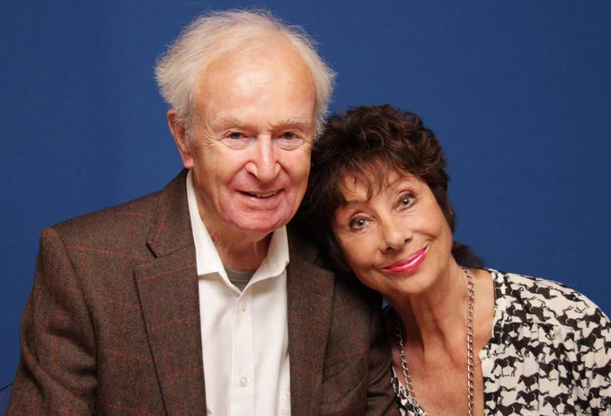 Doctor Who's William Russell and Carole Ann Ford sitting together in front of a blue screen