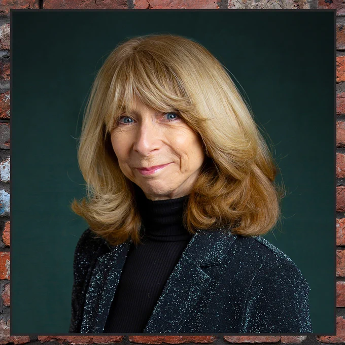 A professional photo of Helen Worth as she smiles proudly. 