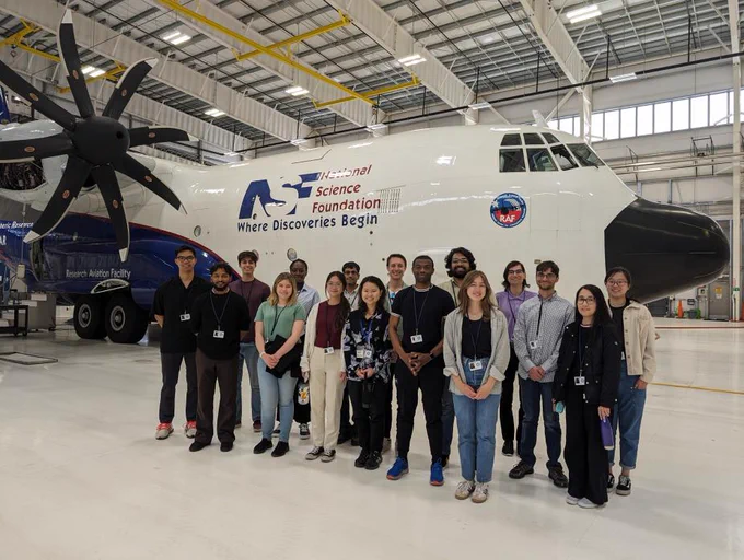 Interns in front of an airplane