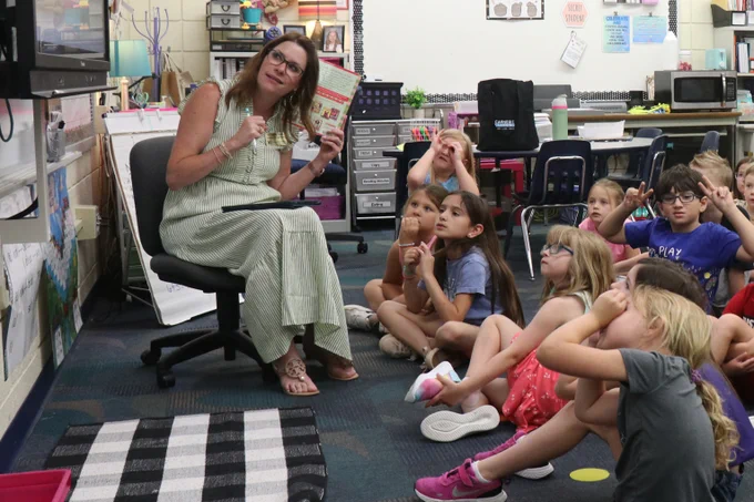 Rockwood students smile while participating in a math and reading game with a district educator.