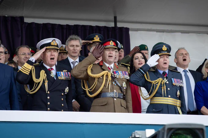 Saluting.