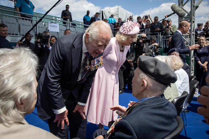Their Majesties speaking to the veterans.