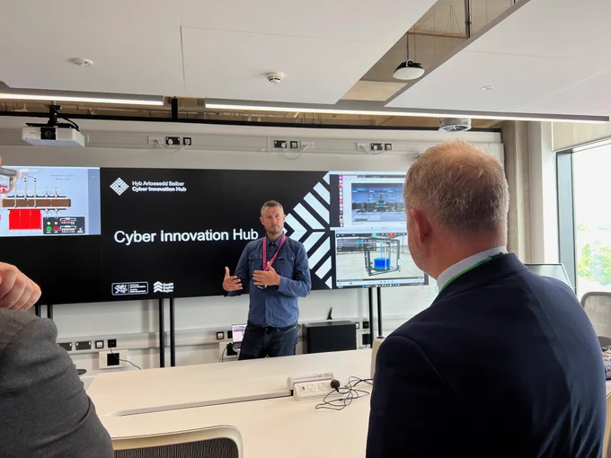 Jeremy Miles receiving presentation from Cyber Innovation Hub