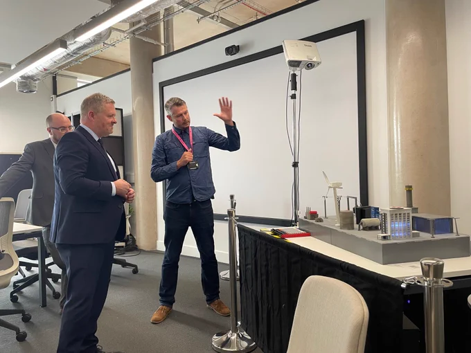Prof Pete Burnap of Cyber Innovation Hub demonstrating model to Jeremy Miles